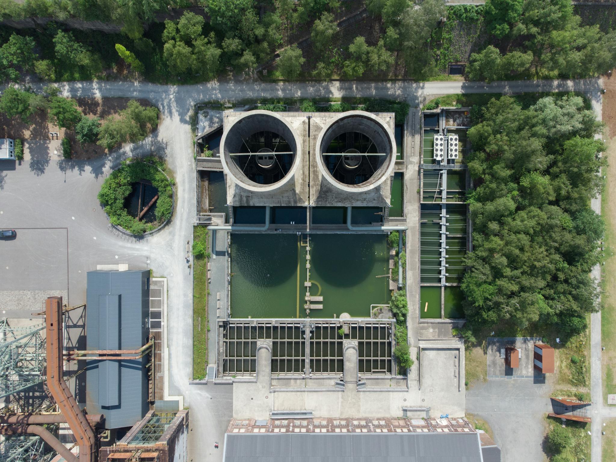 Aerial view of industrial water treatment facility surrounded by greenery in Bochum, Germany.